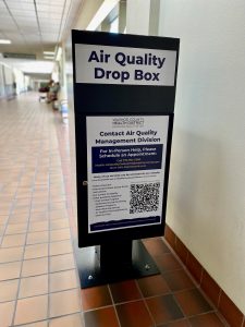 black, air quality management drop box at the county complex hall way. 