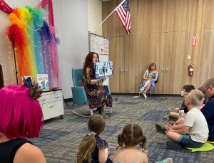 Ginger Devine reads to children and their parents at Drag Story Hour at the Sparks Library.
