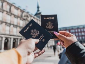 image of two hands holding up passports