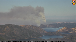 A photo showing a wildfire burning in the distance.
