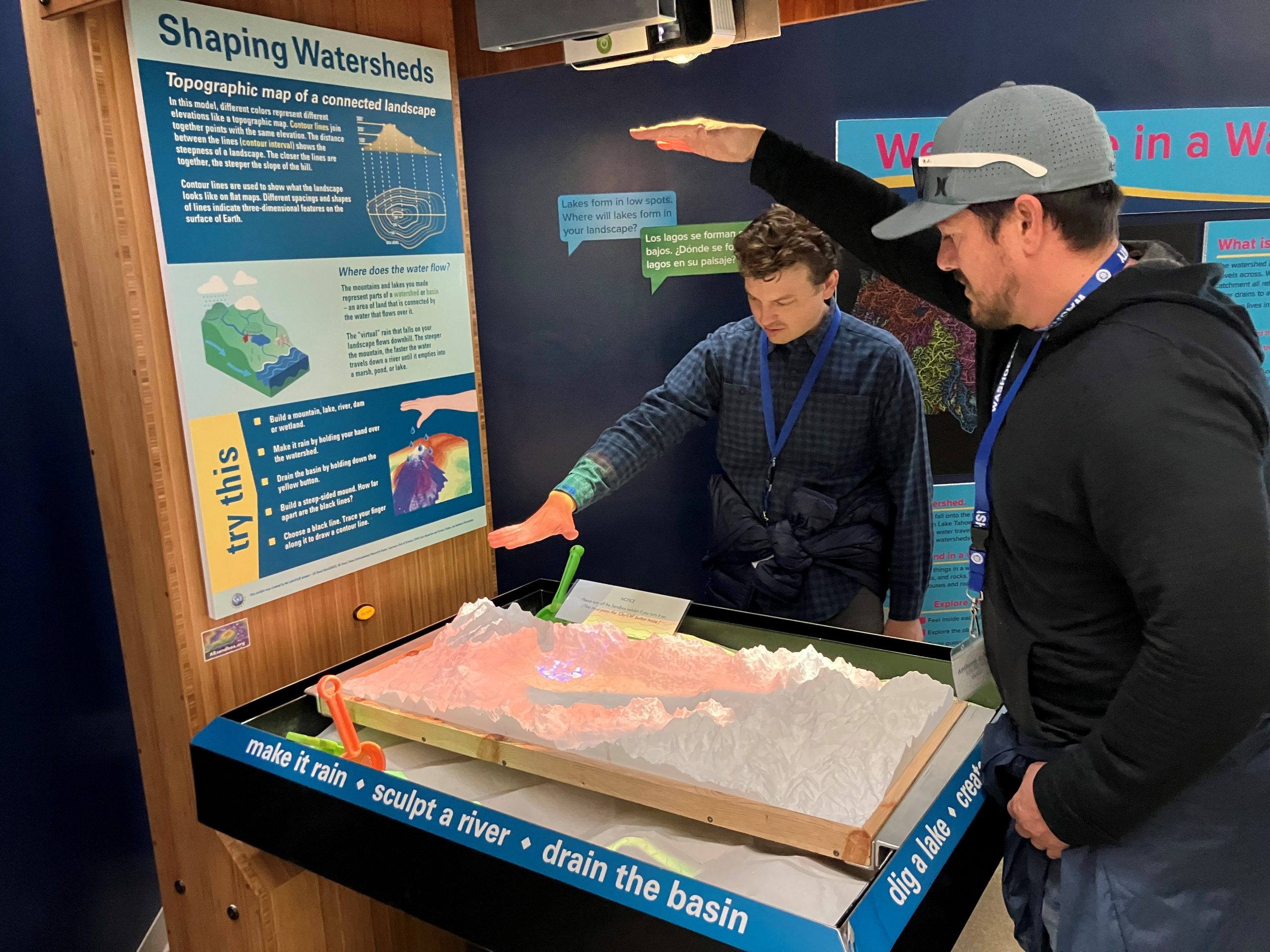 Photo of two men interacting with a science exhibit