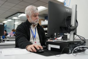 photo of man working at computer