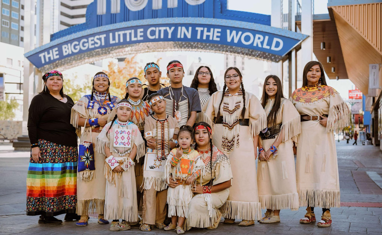 The Eagle Wings Pageant Dance Group poses in front of the Reno arch.