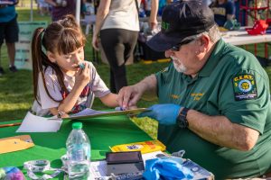 CERT Volunteer working with a child to create a Child I.D.