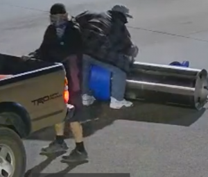 Two suspects lifting stolen vacuum into gold pick-up, case 25-3304