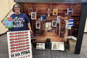 The Branch Manager of the Sierra View Library stands next to their Banned Books Week display.