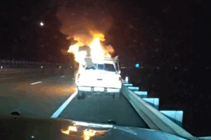 Dash cam image of a vehicle on fire.