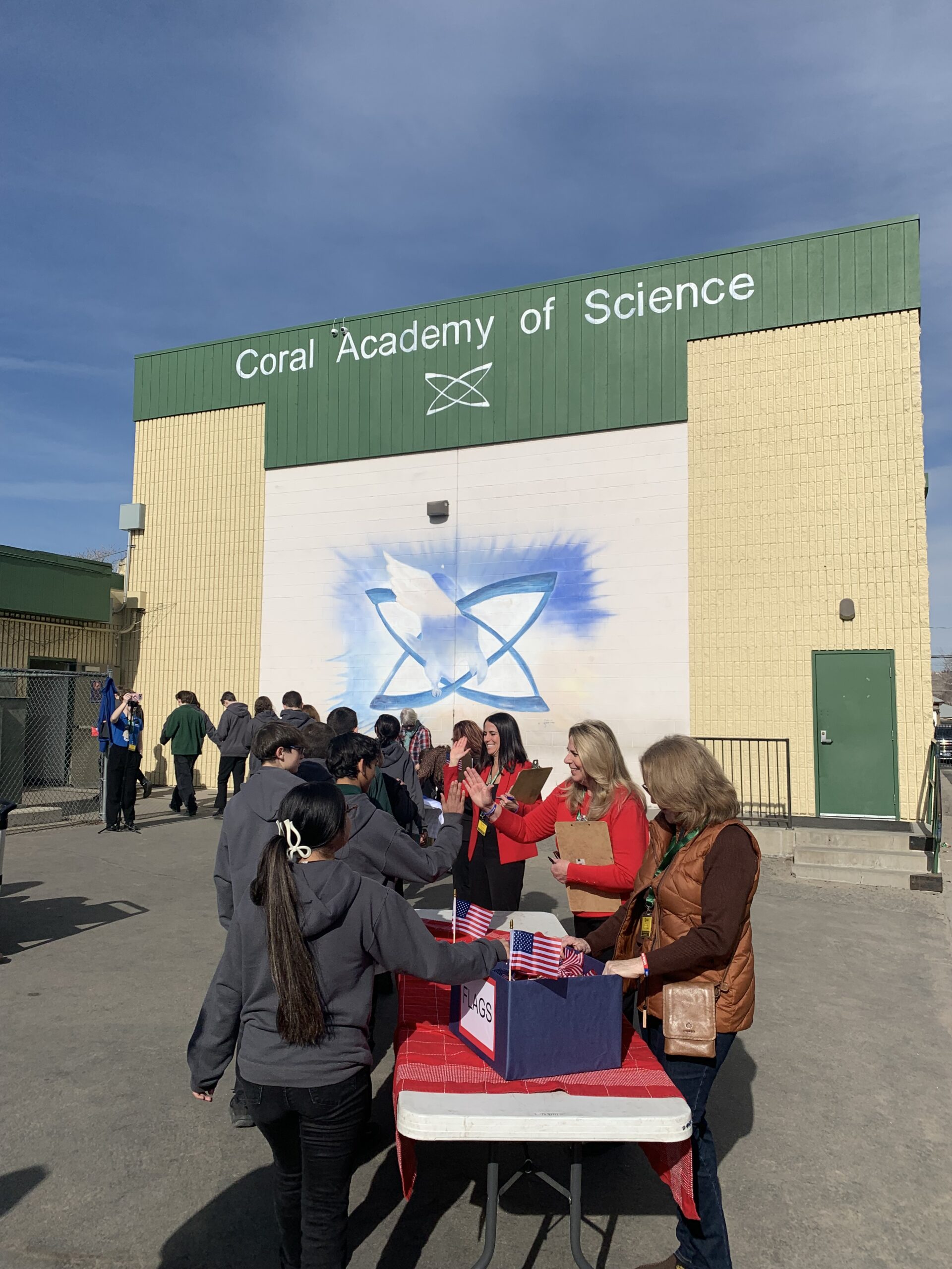 photo of people standing outside the Coral Academy of Science