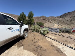 photo depicting a mud flow, closed road, and a Washoe County vehicle.