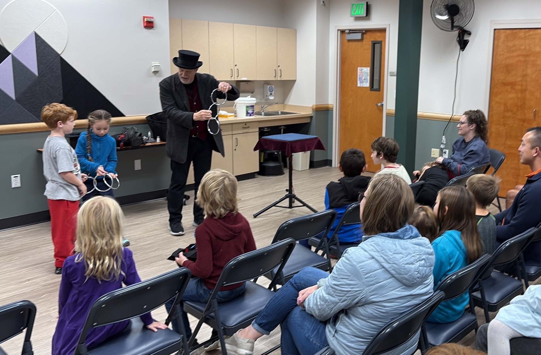 Spellbinders magician entertains a crowd at the Northwest Reno Library